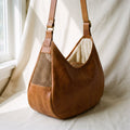 Caramel leather crossbody cat sling carrier with mesh window and adjustable strap, fits cats and small dogs