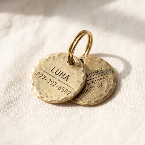 Tiny brass round ID tag for cats, hand-hammered texture, engraved on both sides