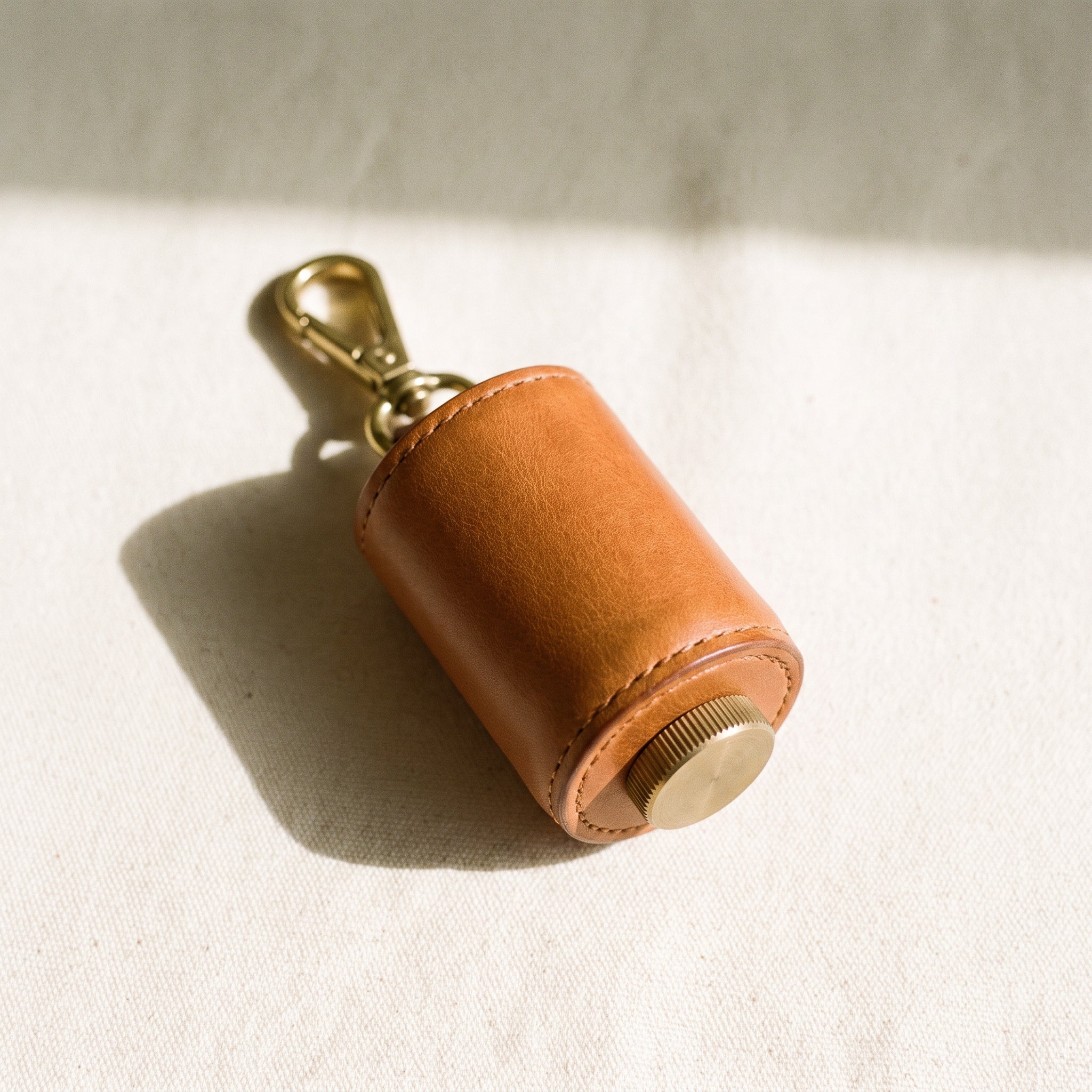 Small tan leather poo bag holder cylinder case with brass carabiner clip